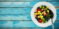 Fresh salad in bowl on blue wooden table Royalty Free Stock Photo