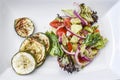 Fresh salad in a bowl in garden, summer time, healthy food.