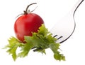 Fresh salad and cherry tomato on fork isolated on white background cutout. Royalty Free Stock Photo