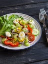 Fresh salad with cherry tomatoes, cucumbers, sweet peppers, celery and quail eggs. Royalty Free Stock Photo