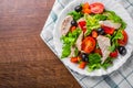 Fresh salad with chicken breast, arugula, black olives,red pepper, lettuce, fresh sald leaves and tomato on a white plate on woode Royalty Free Stock Photo