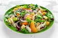 Fresh salad with chicken breast, peach, red onion, croutons and vegetables in a green plate. healthy food Royalty Free Stock Photo