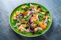 Fresh salad with chicken breast, peach, red onion, croutons and vegetables in a green plate. healthy food Royalty Free Stock Photo