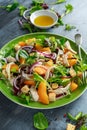 Fresh salad with chicken breast, peach, red onion, croutons and vegetables in a green plate. healthy food Royalty Free Stock Photo