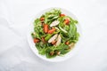 Fresh salad with chicken, tomato and greens (spinach, arugula)