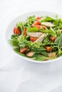 Fresh salad with chicken, tomato and greens (spinach, arugula) on white background close up Royalty Free Stock Photo