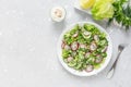 Fresh salad of cucumbers, radishes, green peas and herbs in white bowl. Flat lay Royalty Free Stock Photo