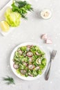 Fresh salad of cucumbers, radishes, green peas and herbs in white bowl. Top view. Vertical orientation Royalty Free Stock Photo