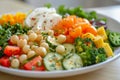 Fresh salad with eggs, tomatoes, cucumbers, chickpeas, and bell peppers