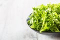 Fresh salad endivia in black bowl on wooden table Royalty Free Stock Photo