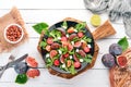 Fresh salad with figs, arugula leaves, cherry tomatoes and feta cheese. Free space for text.