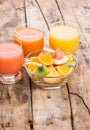 Fresh salad with fruits in glass bowl on wooden table. Royalty Free Stock Photo