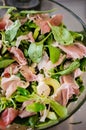 Fresh salad with lamb lettuce, avocado and prosciutto