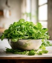 Fresh salad leaves mix in a metal colander, blurred kitchen background Royalty Free Stock Photo
