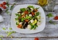 Fresh salad lettuce with mozzarella, tomatoes and olive oil wooden background