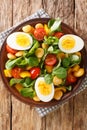 Fresh salad of lupine beans, eggs, tomatoes and Valerianella locusta close-up in a plate. vertical top view Royalty Free Stock Photo
