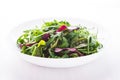 Fresh salad with mixed greens (arugula, mesclun, mache) on white wooden background close up. Royalty Free Stock Photo