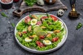 Fresh salad with mussels, quail, egg, conjugate, lime, spinach, lettuce, cherry tomatoes and microgreen. Dietary salad. Food