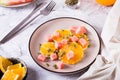 Fresh salad of orange, watermelon and pumpkin seeds on a plate on the table. Organic diet Royalty Free Stock Photo