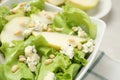 Fresh salad with pear slices in bowl Royalty Free Stock Photo