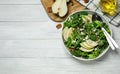 Fresh salad with pear on white wooden table, flat lay. Space for text Royalty Free Stock Photo