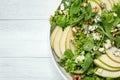 Fresh salad with pear on white wooden table, top view. Space for text Royalty Free Stock Photo