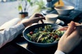 fresh salad in a plate delicious food diet fork in hand female hands cafe Royalty Free Stock Photo