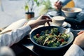 fresh salad in a plate delicious food diet fork in hand female hands cafe Royalty Free Stock Photo