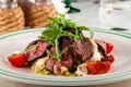 Fresh salad plate with meat, tomato and mixed greens arugula, mesclun, mache close up. Healthy food. Clean eating Royalty Free Stock Photo