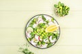 Fresh salad with radish, cucumber, green pea, sunflower and soy sprouts, edamame and olive oil. Vegetarian. vegan healthy food. Royalty Free Stock Photo