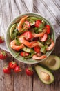 Fresh salad with shrimp, avocado and strawberry close-up. vertical top view