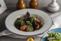 Fresh salad with shrimp, tomato and mixed greens in white bowl on the table Healthy food Royalty Free Stock Photo