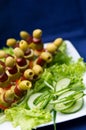 Fresh salad and skewered olives