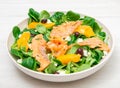 Fresh salad with sliced of marinated salmon and orange fruit Royalty Free Stock Photo