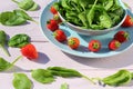 Fresh salad with spinach and strawberries on wooden light pink table Royalty Free Stock Photo