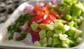 A bowl of fresh and organic salad with onion, tomato, cucumber and green chilly,