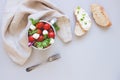 Fresh salad with tomato and ciabatta bread with cream cheese on the gray background Royalty Free Stock Photo