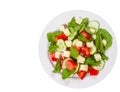 Fresh salad with tomatoes, arugula, cucumber and cheese cubes. top view. isolated Royalty Free Stock Photo