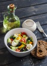 Fresh salad with tomatoes, cucumbers, peppers, olives and cheese in a ceramic bowl Royalty Free Stock Photo