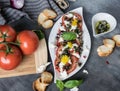 Fresh salad of tomatoes and mozzarella. Recipe with olive oil with red onion, olives and basil Royalty Free Stock Photo