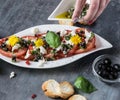 Fresh salad of tomatoes and mozzarella. Recipe with olive oil with red onion, olives and basil Royalty Free Stock Photo