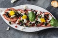 Fresh salad of tomatoes and mozzarella. Recipe with olive oil with red onion, olives and basil Royalty Free Stock Photo