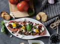 Fresh salad of tomatoes and mozzarella. Recipe with olive oil with red onion, olives and basil Royalty Free Stock Photo