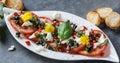 Fresh salad of tomatoes and mozzarella. Recipe with olive oil with red onion, olives and basil Royalty Free Stock Photo