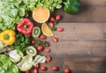 Fresh salad vegetables and fruit on wood background. Royalty Free Stock Photo