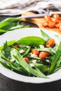 Fresh salad with wild garlic,tomatoes and feta cheese on plate