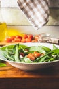 Fresh salad with wild garlic,tomatoes and feta cheese on plate