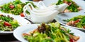 Fresh salads on the plates and sause Royalty Free Stock Photo