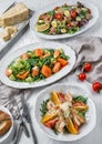 Fresh salads with salmon, shrimps, tuna, arugula, greens, parmesan, tomatoes, eggs on plates over light wooden background. Healthy Royalty Free Stock Photo