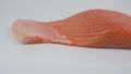 Fresh salmon fillet decorated with black pepper, pink Himalayan salt and lemon on a white background